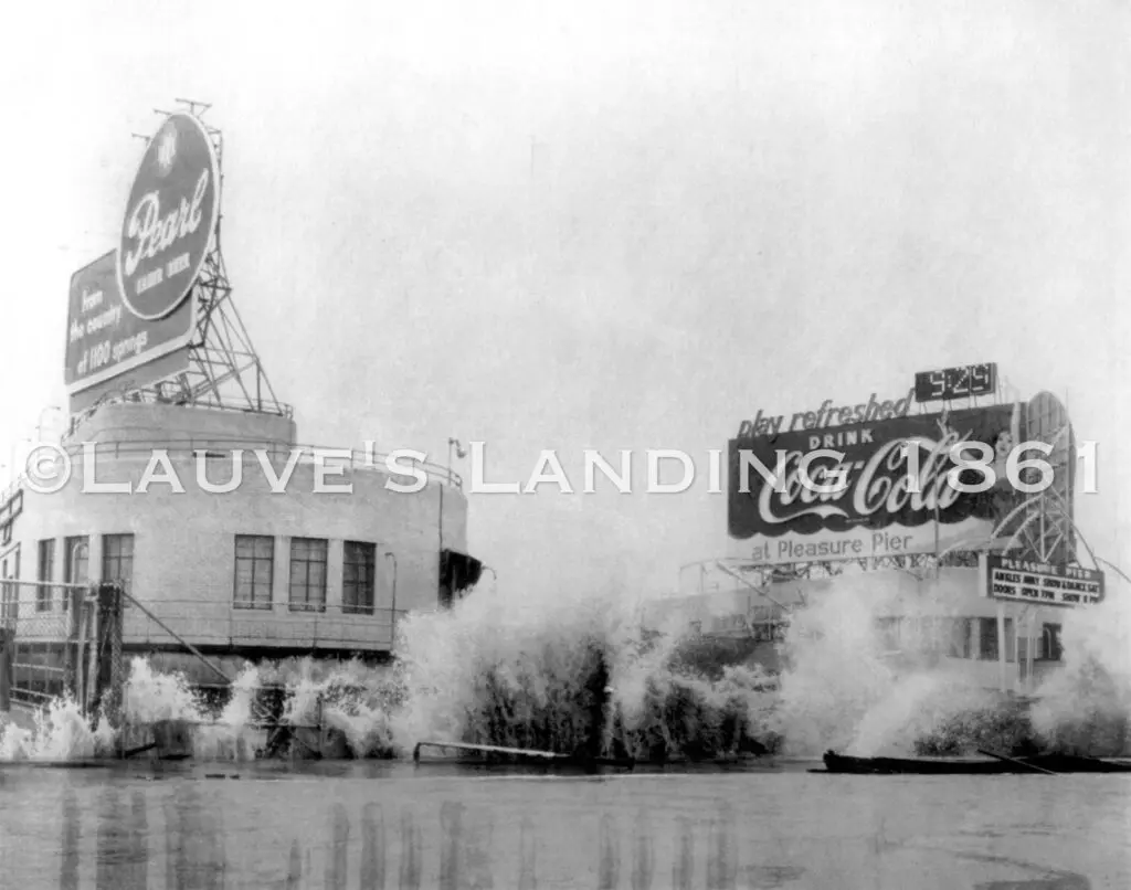 A heritage-inspired black and white photo featuring a coca cola sign immersed in the water.