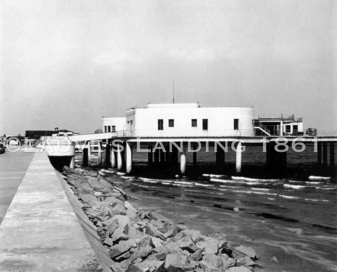 An old black and white photo of a pier.